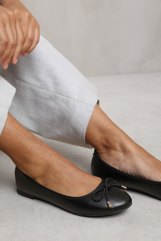 TALLULAH WIDE FIT SLIP ON FLAT PUMPS IN BLACK FAUX LEATHER