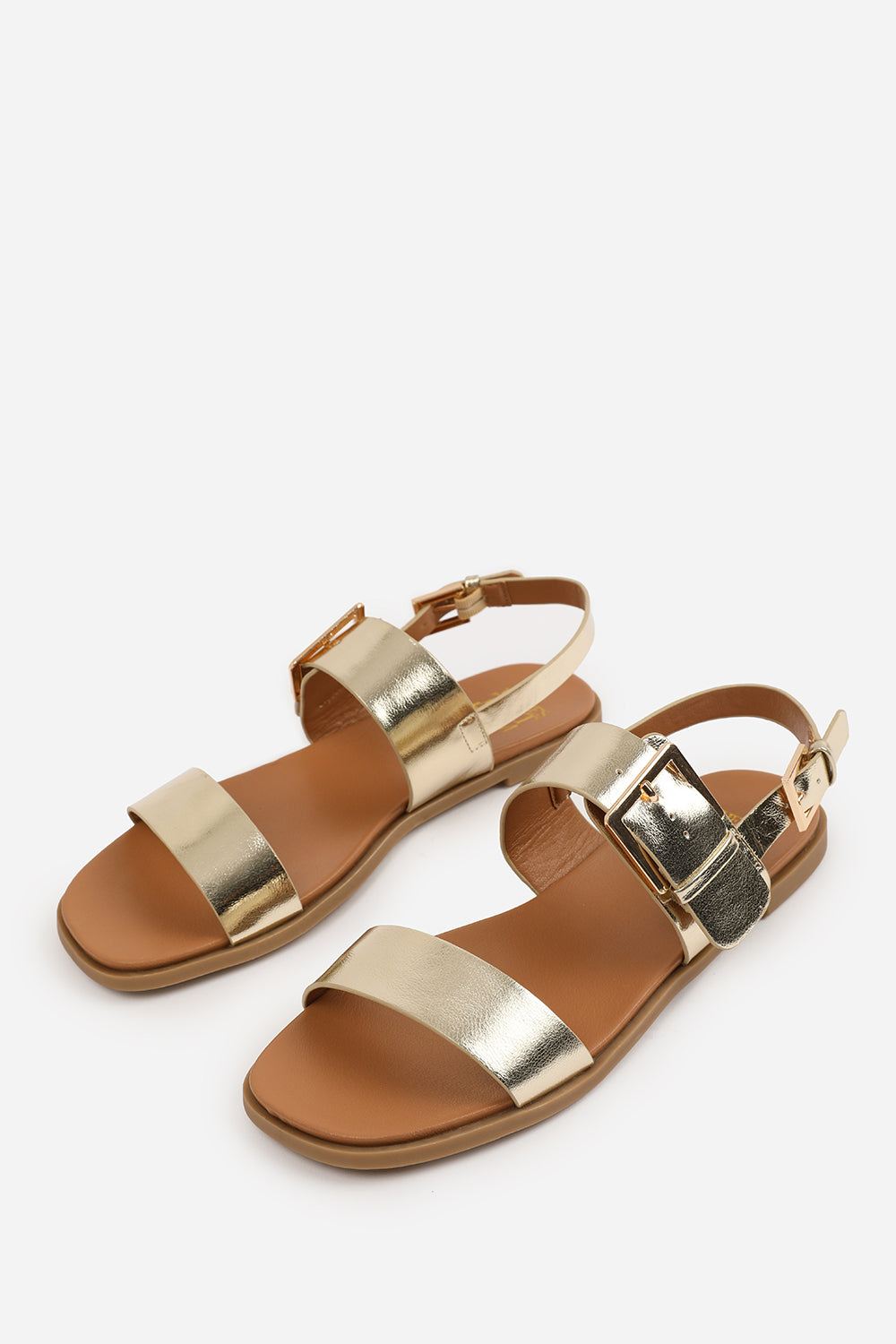 CAMILLA WIDE FIT CLASSIC FLAT SANDALS WITH STRAP AND BUCKLE DETAIL IN GOLD METALLIC FAUX LEATHER