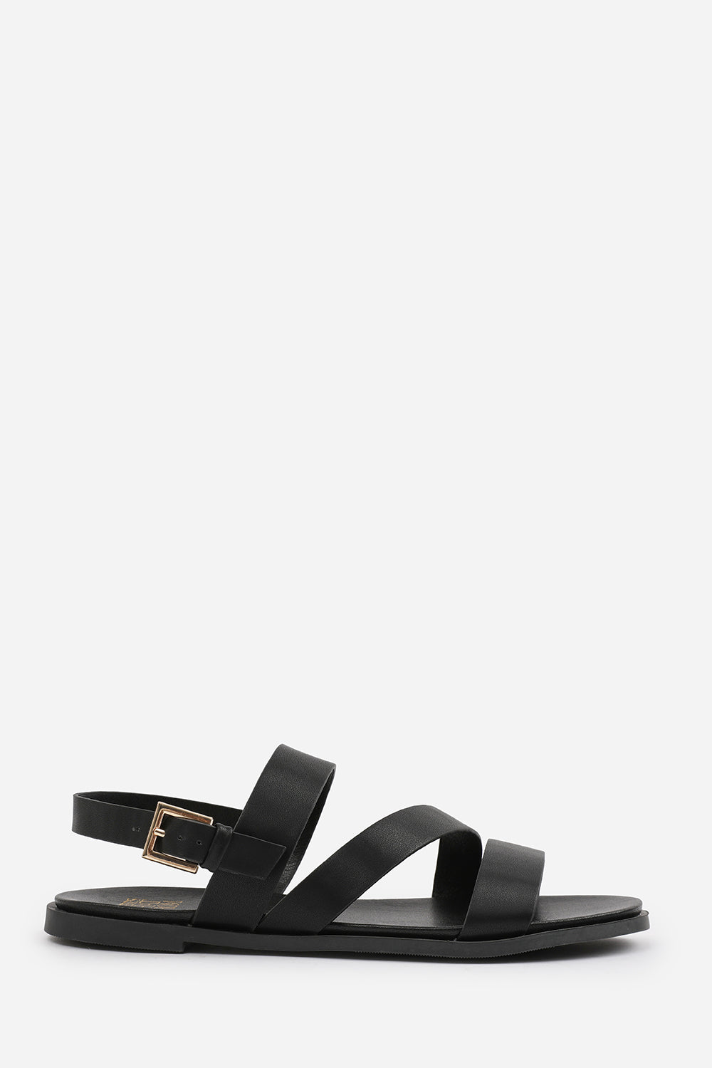 NESSA WIDE FIT FLAT SANDALS WITH CROSS OVER STRAP AND BUCKLE CLOSURE IN BLACK FAUX LEATHER
