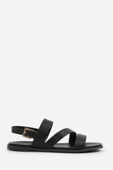 NESSA WIDE FIT FLAT SANDALS WITH CROSS OVER STRAP AND BUCKLE CLOSURE IN BLACK FAUX LEATHER