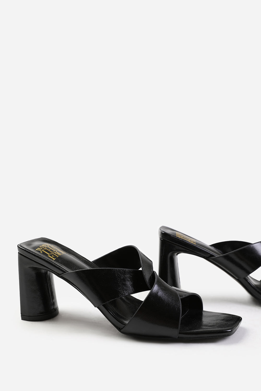 MANILA TWIST OVER STRAP BLOCK HEEL MULES IN BLACK FAUX LEATHER