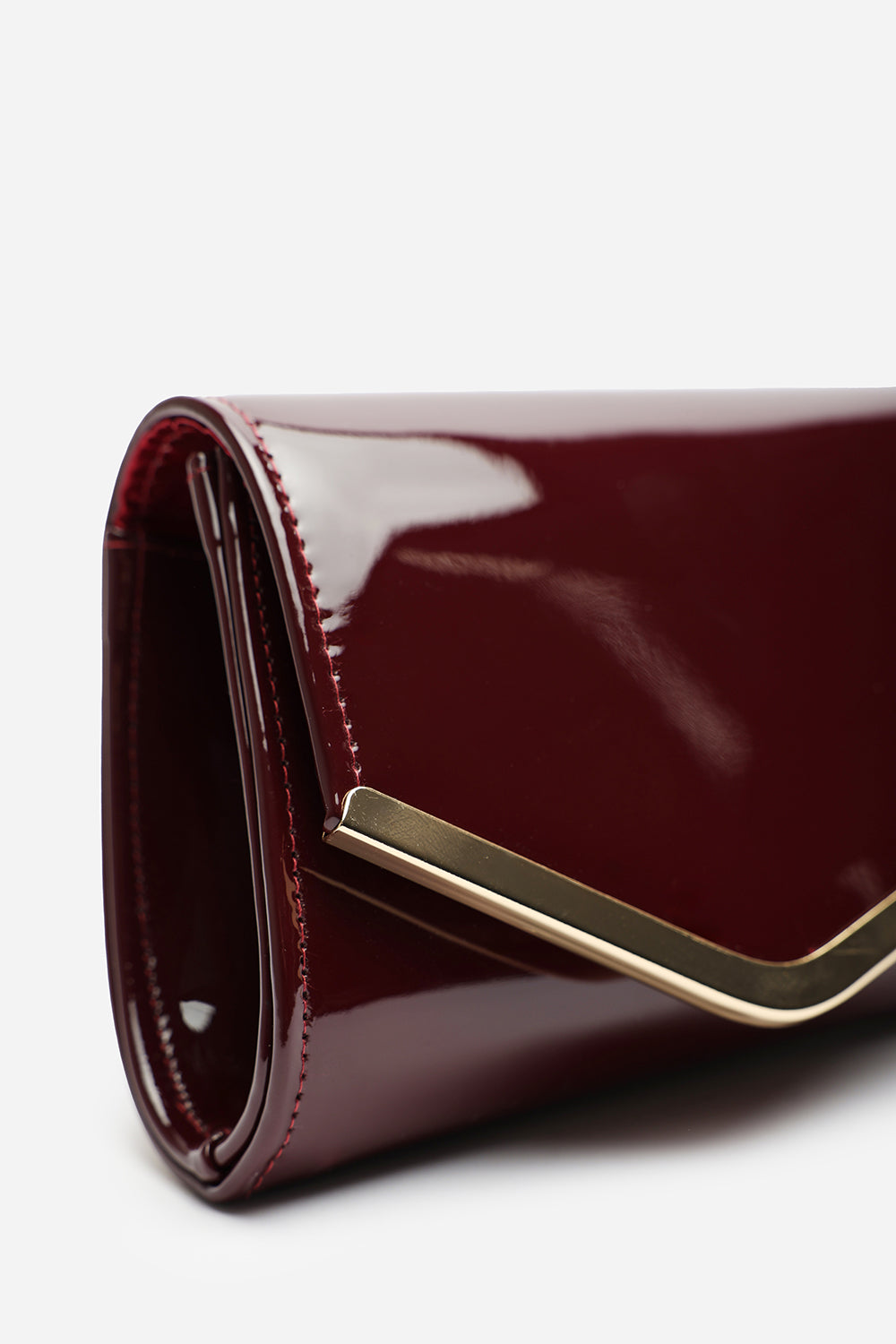 Hovena Burgundy Patent Asymmetric Envelope Clutch With Silver Trim