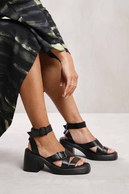 ARIEL MID HIGH BLOCK HEEL SANDALS WITH BUCKLE DETAIL IN BLACK FAUX LEATHER