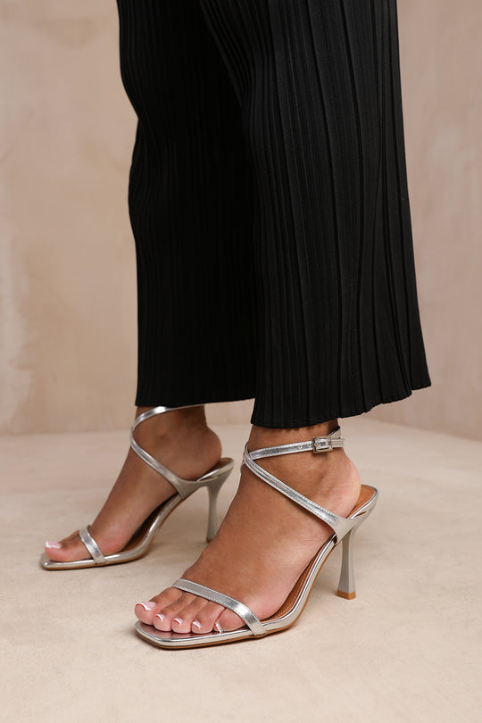NIEVE WIDE FIT CROSS OVER STRAP BARELY THERE HIGH HEELS IN SILVER METALLIC FAUX LEATHER