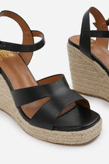 SANSA WIDE FIT CUT OUT STRAP DETAIL WEDGE SHOES WITH BUCKLE CLOSURE IN BLACK GRAIN PU