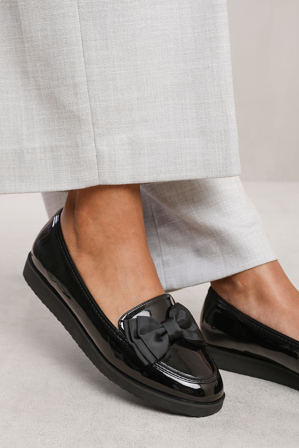 AMITY SLIP ON LOAFER SLIDER WITH BOW DETAIL IN BLACK PATENT