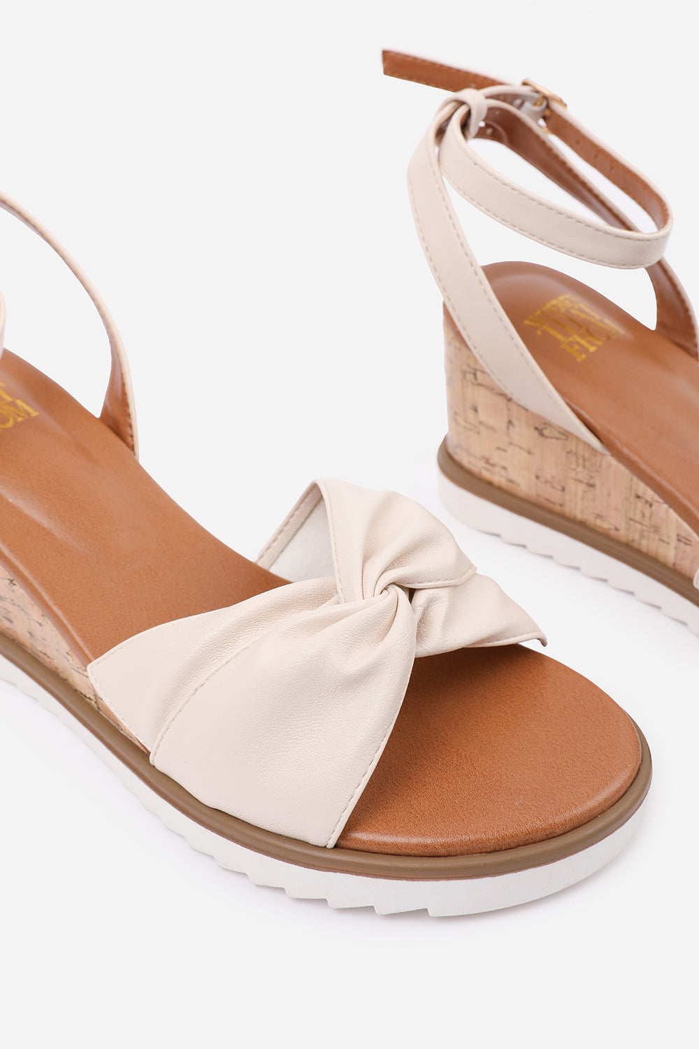 KATARA WIDE FIT KNOT DETAIL WEDGE SHOES WITH BUCKLE ANKLE STRAP IN CREAM PU