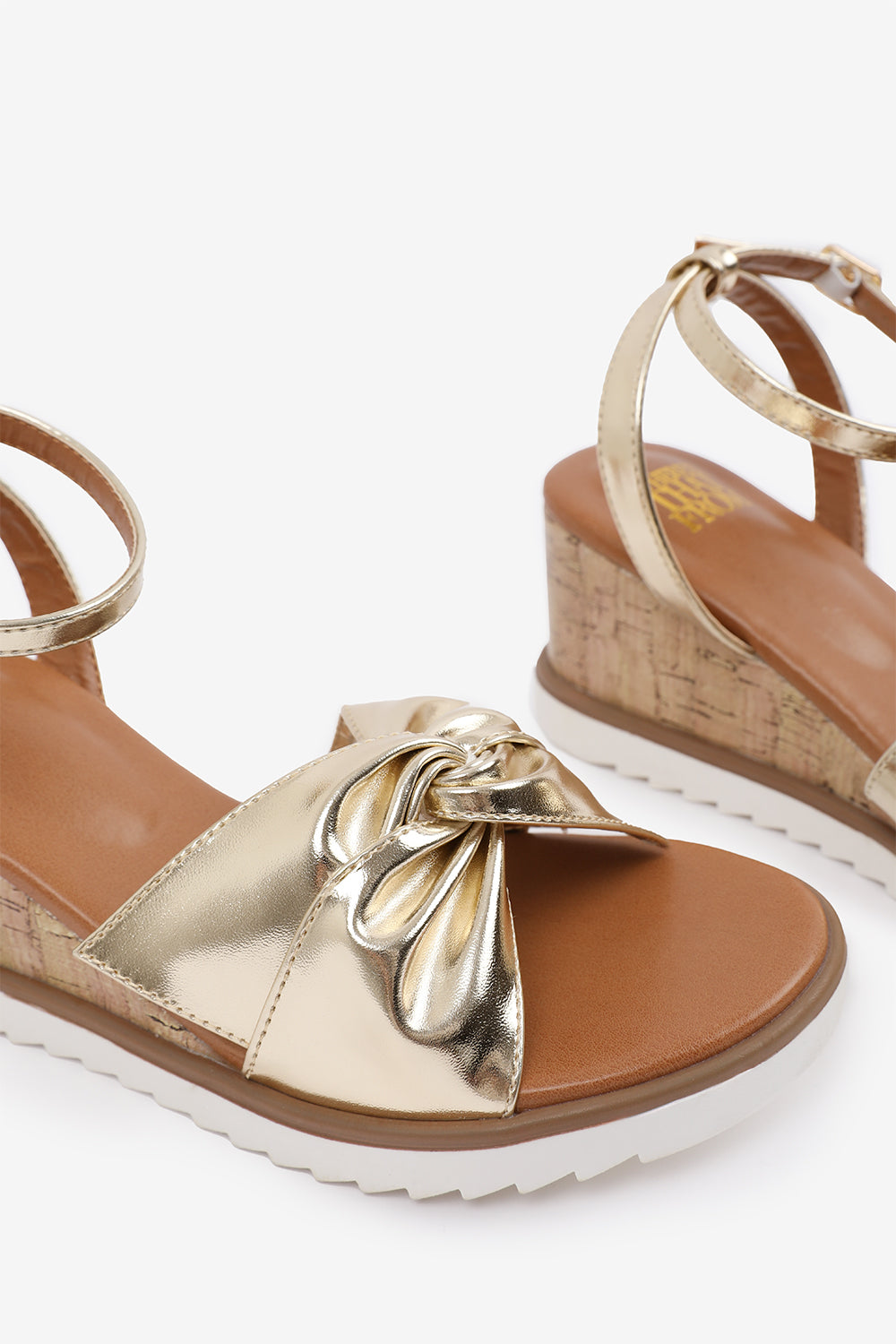 KATARA WIDE FIT KNOT DETAIL WEDGE SHOES WITH BUCKLE ANKLE STRAP IN GOLD METALLIC PU