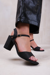 PAITYN BUCKLE UP LOW BLOCK HEEL SANDAL IN BLACK GLITTER