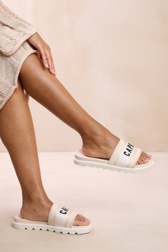 AUTUMN FLAT SANDAL WITH TEXT DETAILING AND PRINTED SOLE IN CREAM