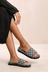 CATHERINE FLAT SANDAL WITH PATTERNED STRAP DETAIL IN GREY FAUX LEATHER