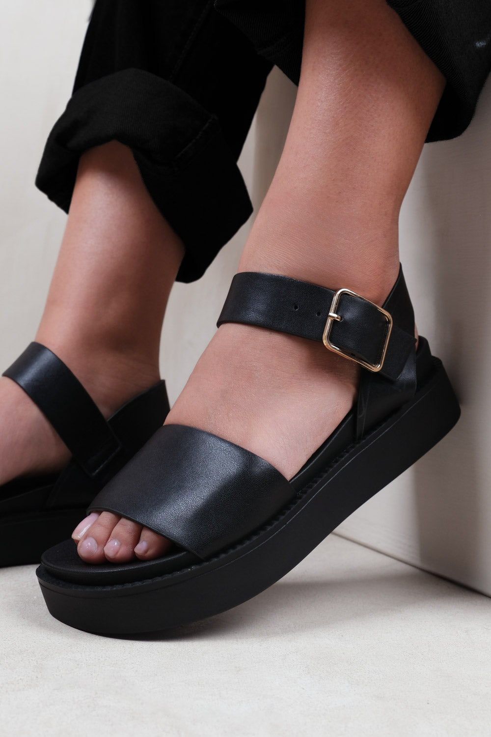 PHOENIX EXTRA WIDE FIT CLASSIC FLAT SANDALS WITH STRAP AND BUCKLE DETAIL IN BLACK FAUX LEATHER