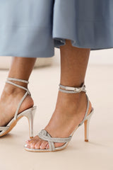 ISEPPA DIAMANTE KNOT DETAIL WITH CROSS OVER ANKLE STRAP HIGH HEELS IN SILVER CHROME