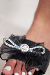 KEDENCE DIAMANTE BOW SLIP ON SLIDES FLAT SANDALS IN BLACK FAUX LEATHER